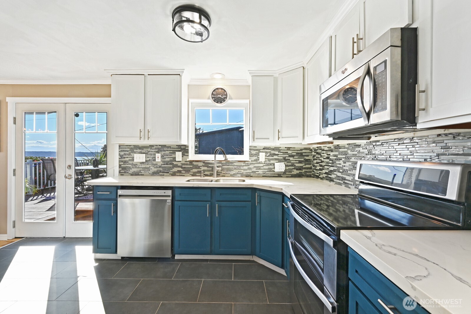 8451 40th Avenue Southwest Seattle, WA 98136 - Photo 12 of 37 a kitchen with stainless steel appliances granite countertop a sink and a stove