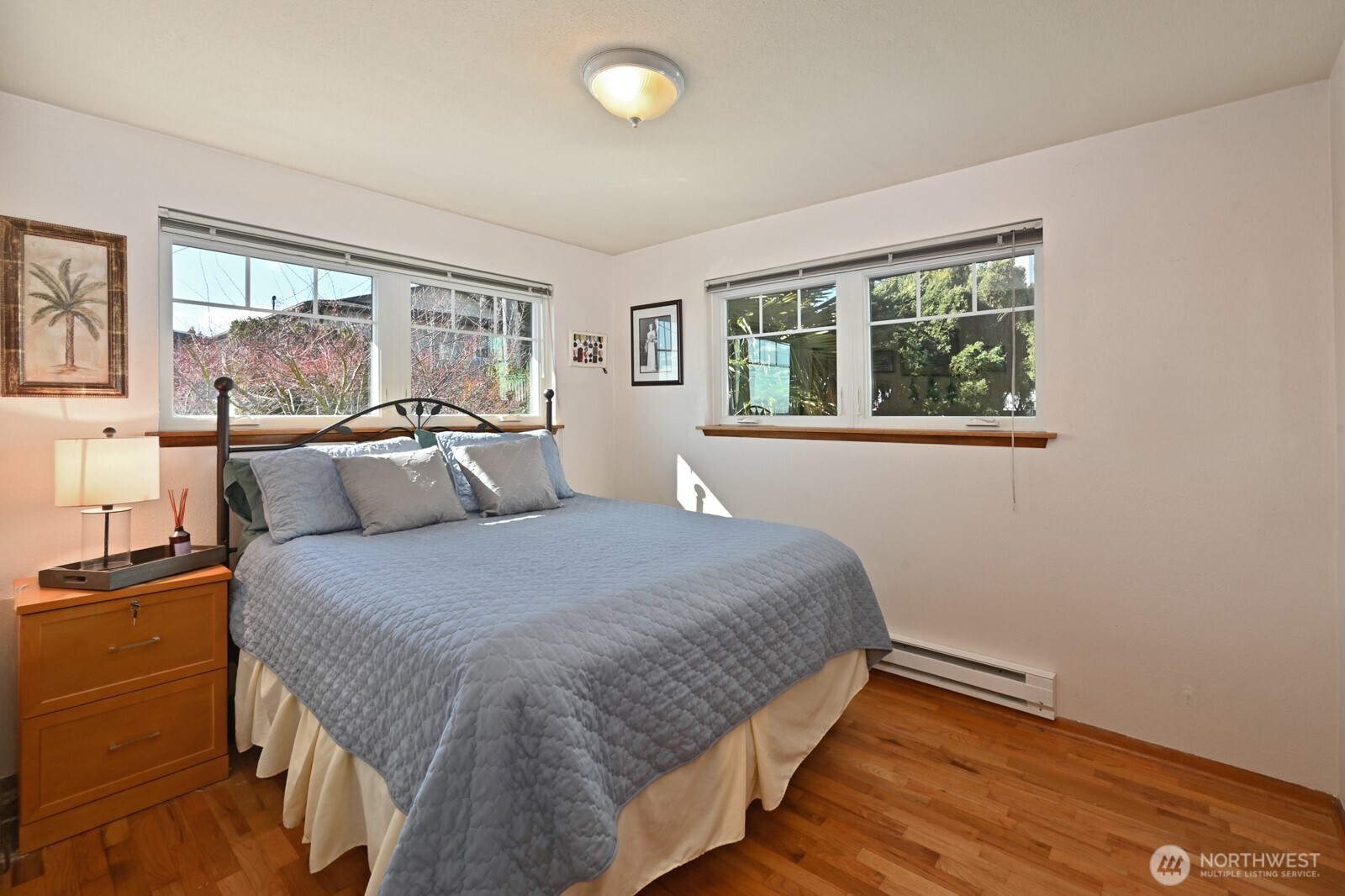 8451 40th Avenue Southwest Seattle, WA 98136 - Photo 13 of 37 a spacious bedroom with a bed and large windows