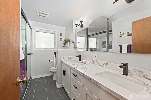 a bathroom with a sink a vanity and a mirror