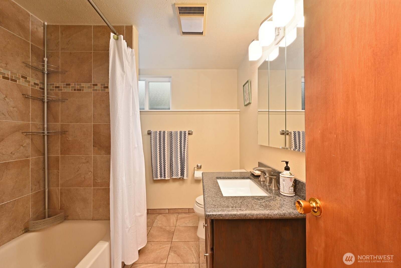 8451 40th Avenue Southwest Seattle, WA 98136 - Photo 20 of 37 a bathroom with a sink and mirror