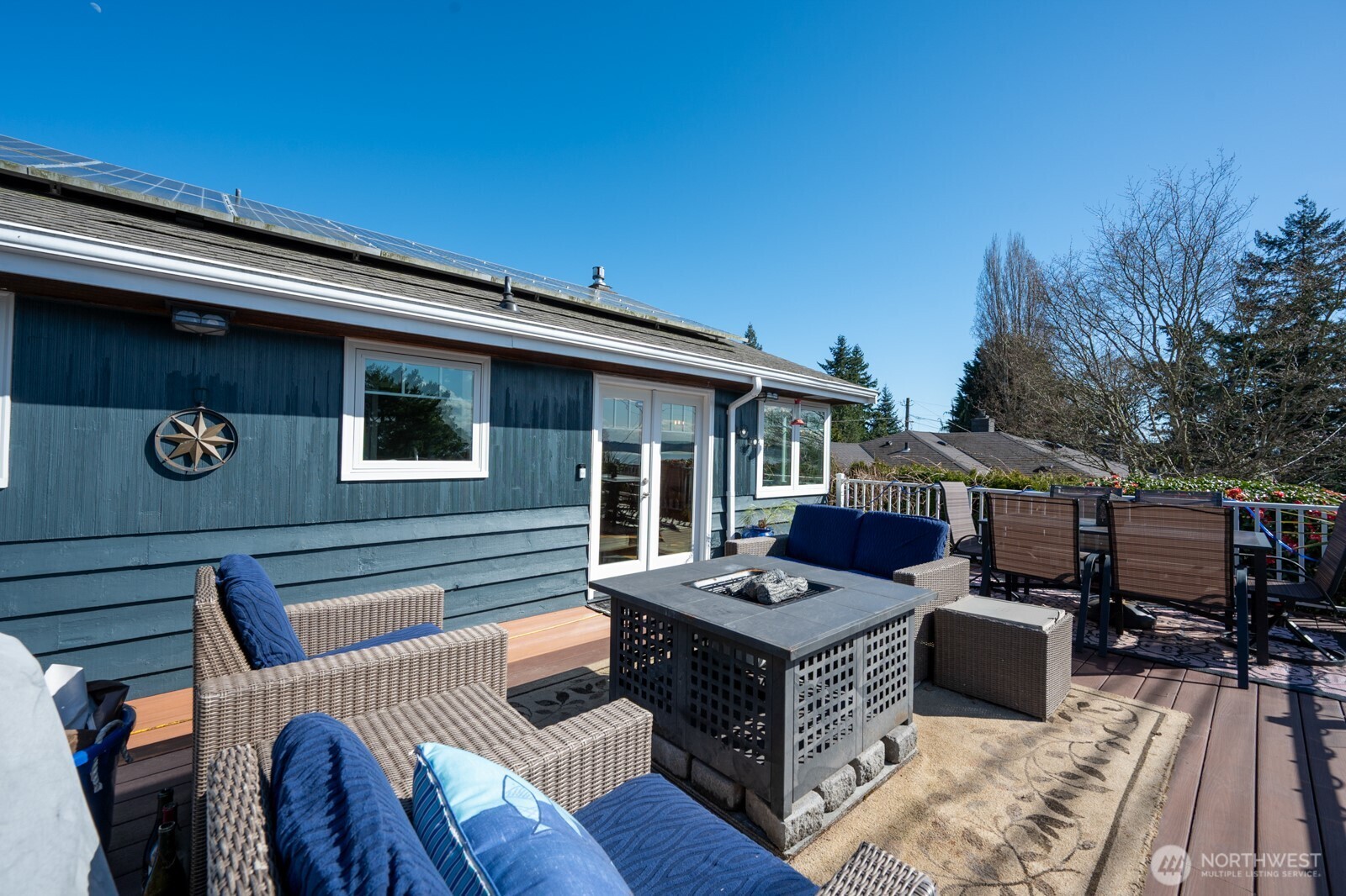 8451 40th Avenue Southwest Seattle, WA 98136 - Photo 25 of 37 a view of a patio with couches table and chairs with wooden floor and fence