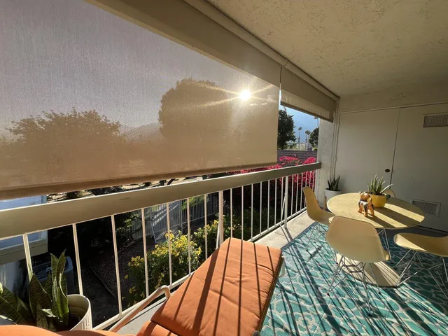 a view of balcony with wooden floor and outdoor seating