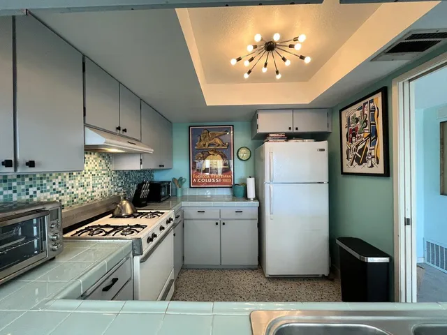 a kitchen with cabinets and steel stainless steel appliances