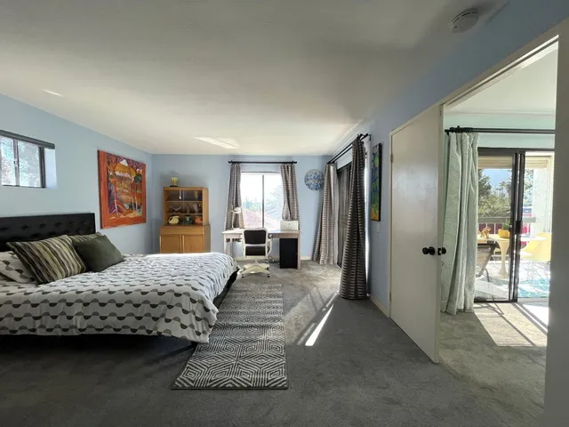 a bedroom with a large bed and a walk in closet