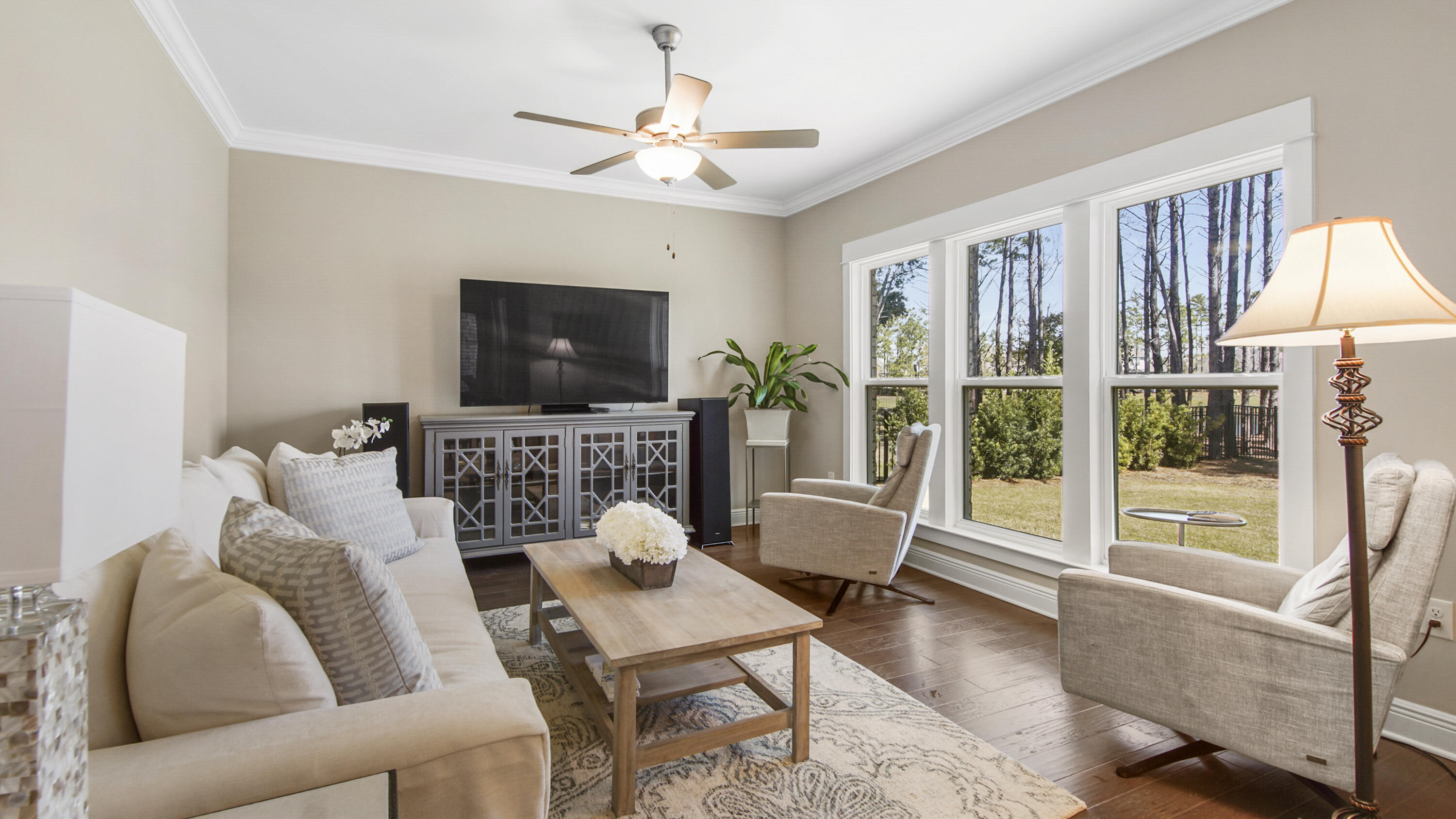 194 Mill Pond Cove Freeport, FL 32439 - Photo 14 of 89 a living room with furniture a flat screen tv and a large window