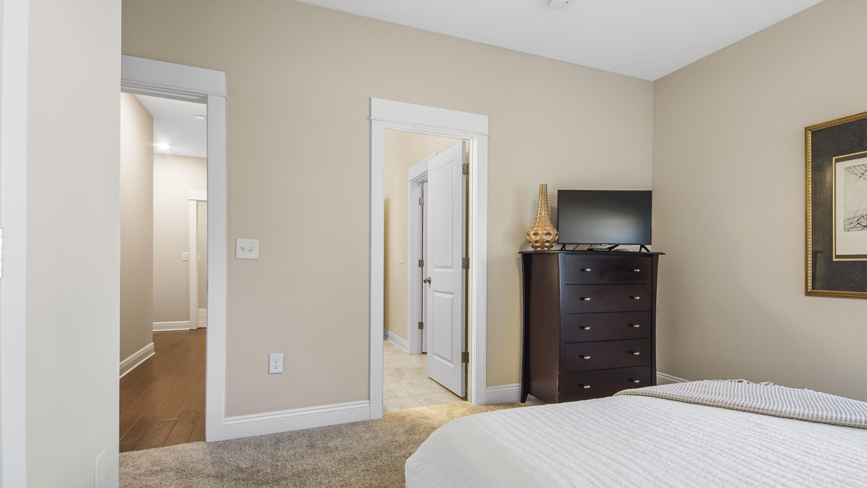 194 Mill Pond Cove Freeport, FL 32439 - Photo 30 of 89 a bedroom with a bed and a tv on dresser