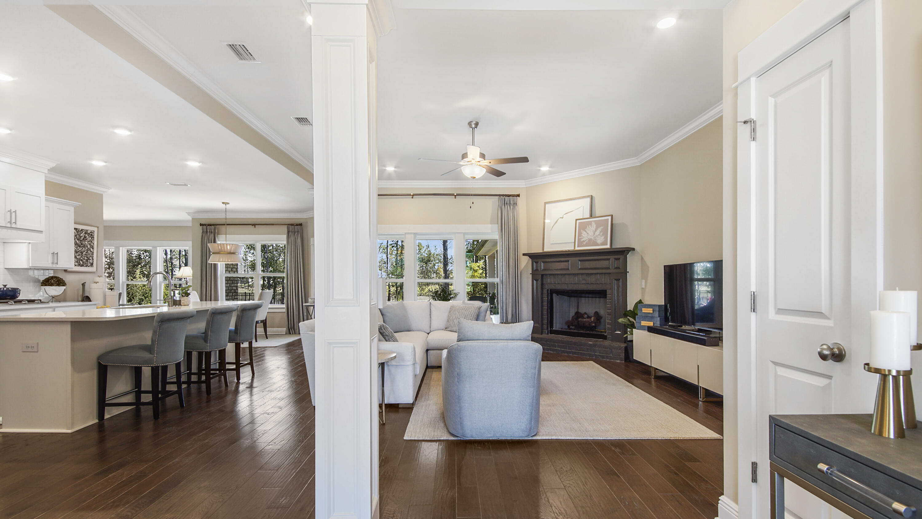 194 Mill Pond Cove Freeport, FL 32439 - Photo 3 of 89 a living room with furniture a fireplace and a dining table with wooden floor