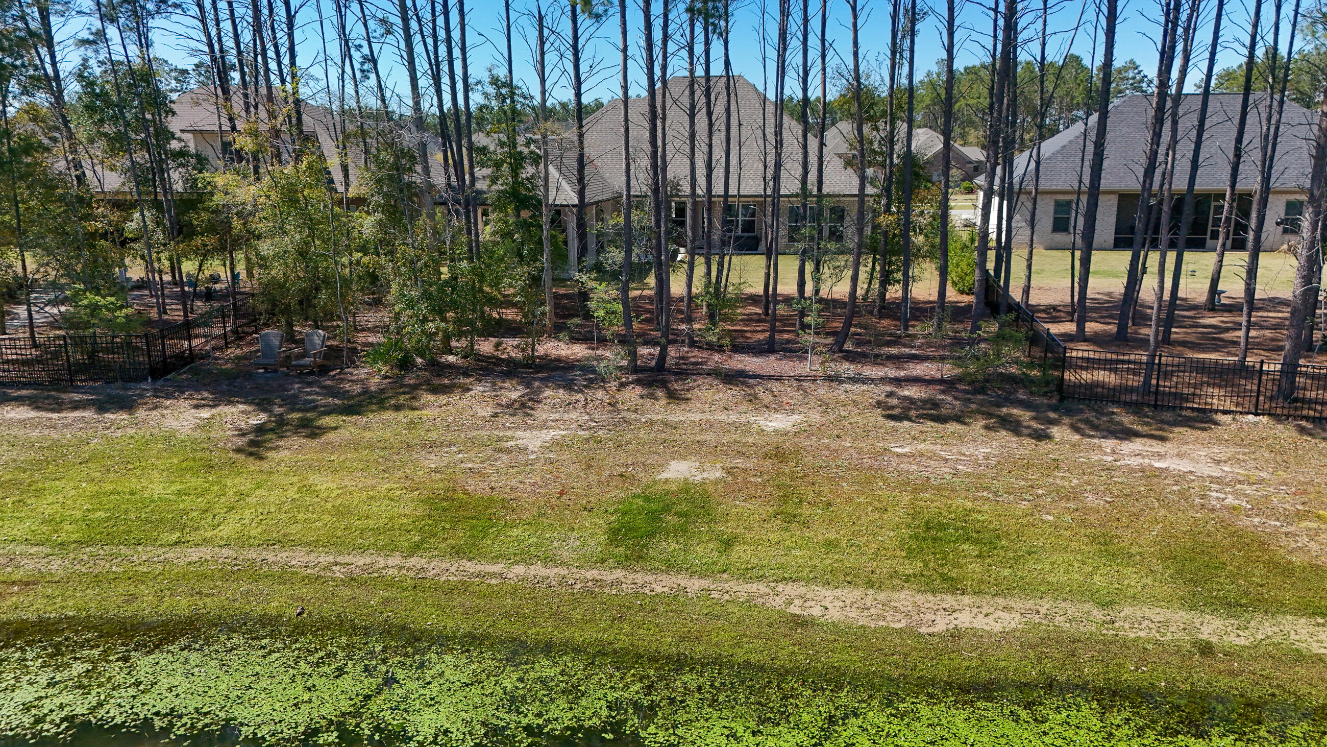 194 Mill Pond Cove Freeport, FL 32439 - Photo 51 of 89 a view of swimming pool with lawn chairs and wooden fence