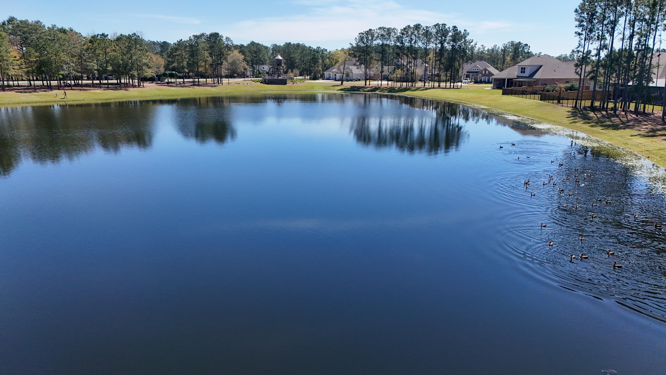 194 Mill Pond Cove Freeport, FL 32439 - Photo 52 of 89 a view of a lake with boats and trees in the background