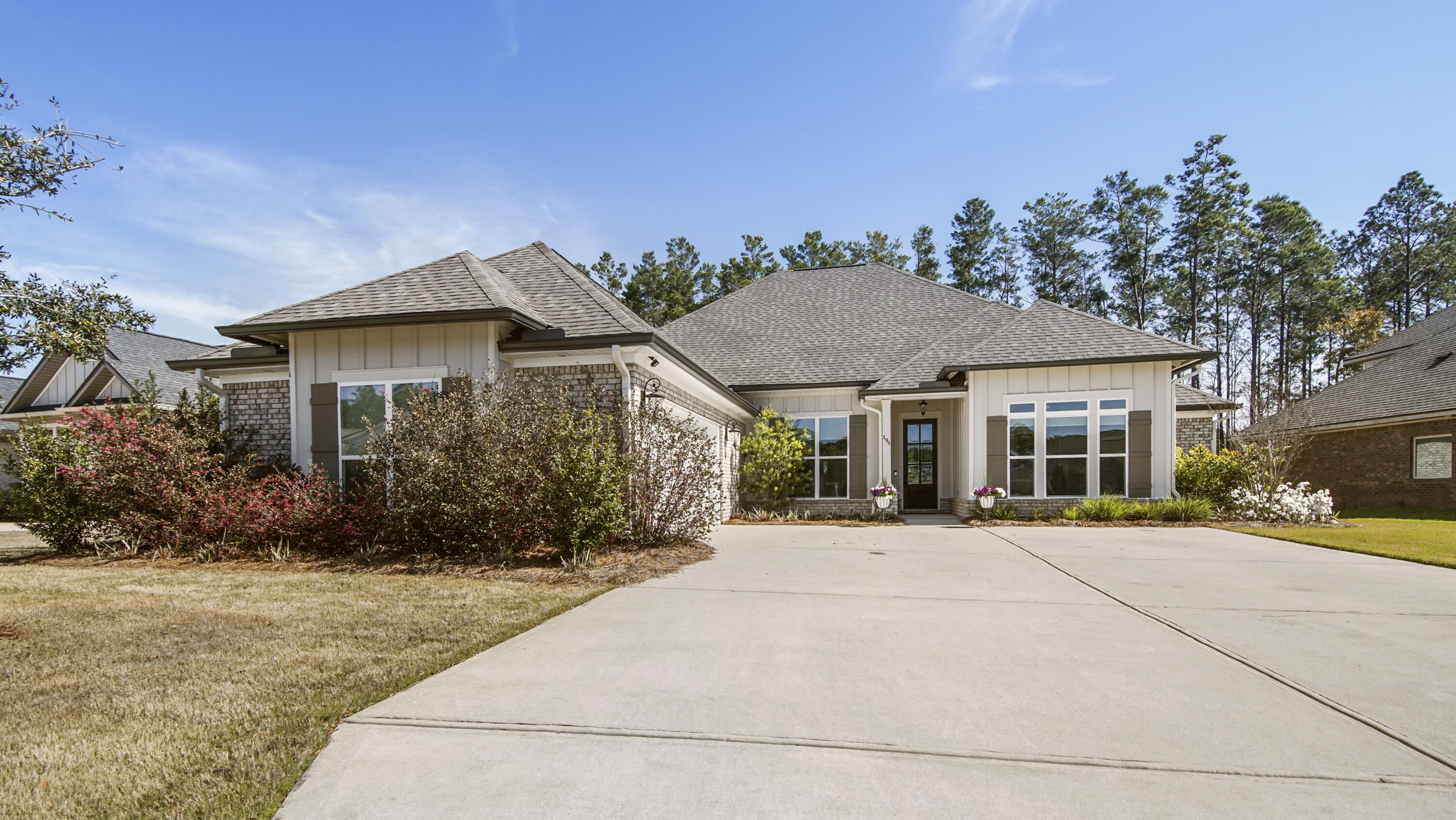 194 Mill Pond Cove Freeport, FL 32439 - Photo 57 of 89 a front view of a house with a garden