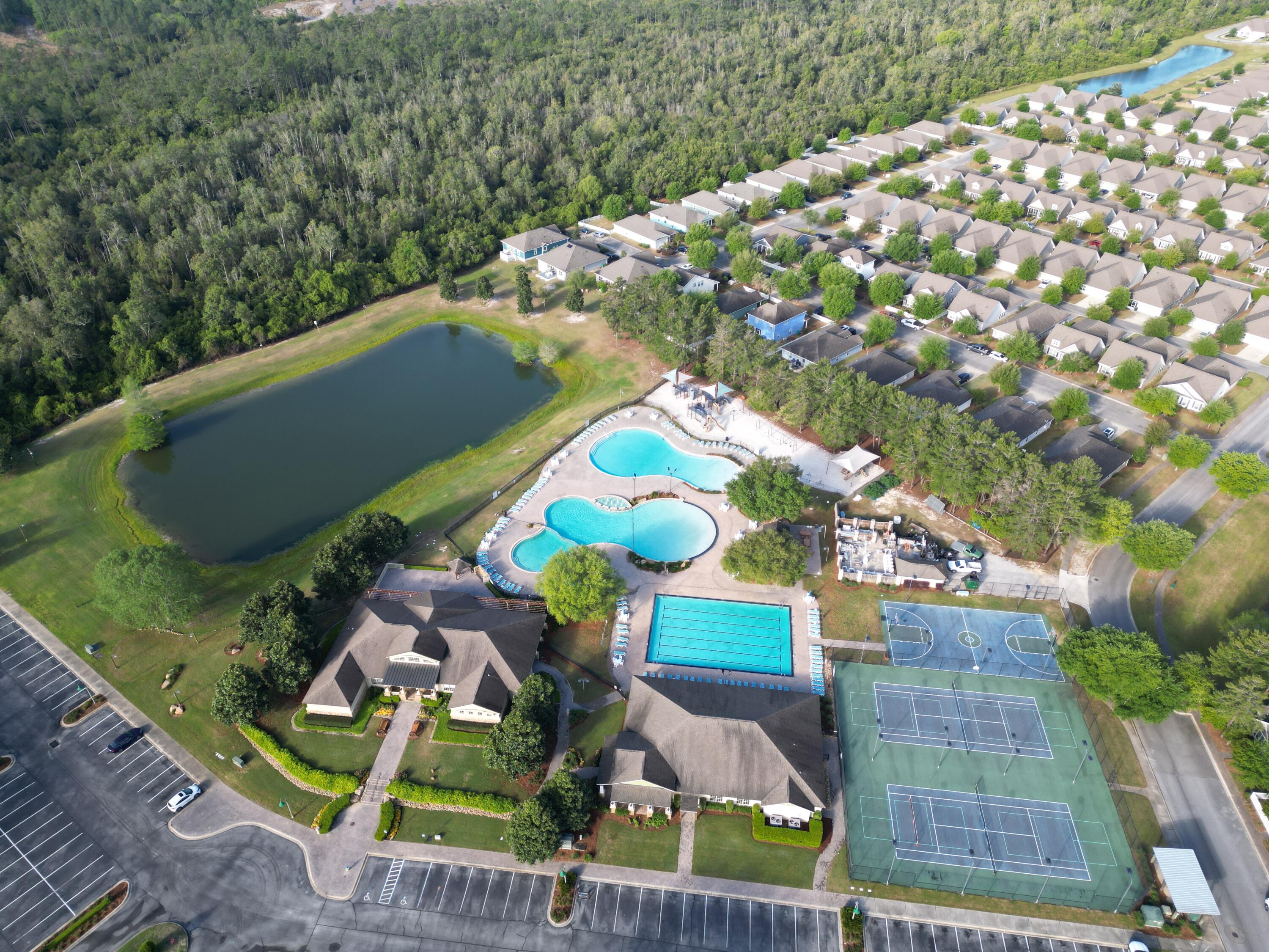 194 Mill Pond Cove Freeport, FL 32439 - Photo 63 of 89 a view of a backyard with plants and outdoor seating