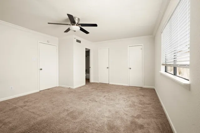 a view of empty room with ceiling fan