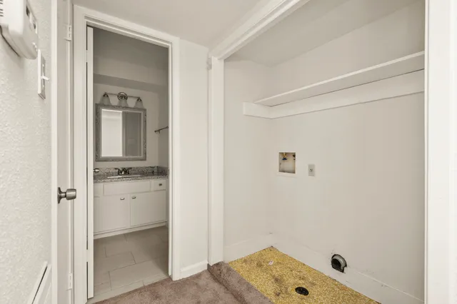 a bathroom with a tub shower vanity and a sink