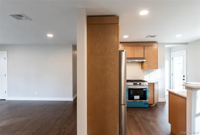 a view of a kitchen with furniture and wooden floor