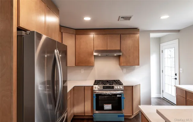 a kitchen with stainless steel appliances a refrigerator a stove and a sink