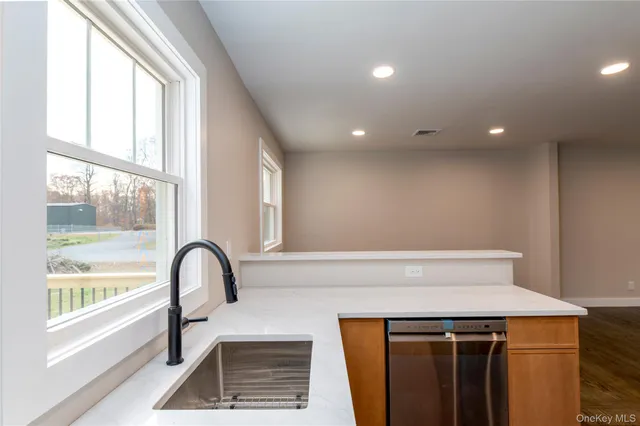 a view of a kitchen with a sink and a window