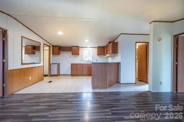 a view of a kitchen with furniture and wooden floor