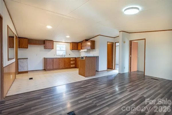 a view of kitchen with stainless steel appliances refrigerator stove microwave and cabinets