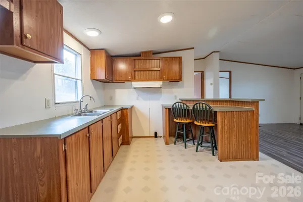 a kitchen with sink cabinets and outdoor space