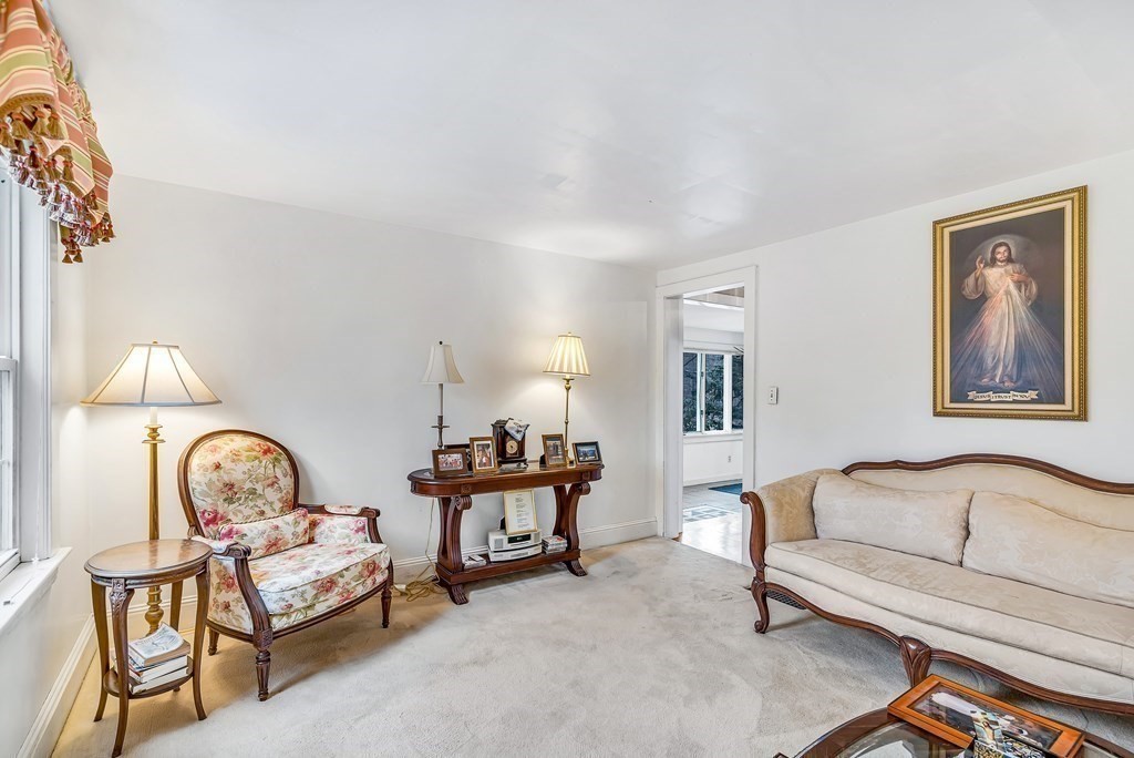 105 Hartford Street Natick, MA 01760 - Photo 15 of 41 a living room with furniture and a mirror