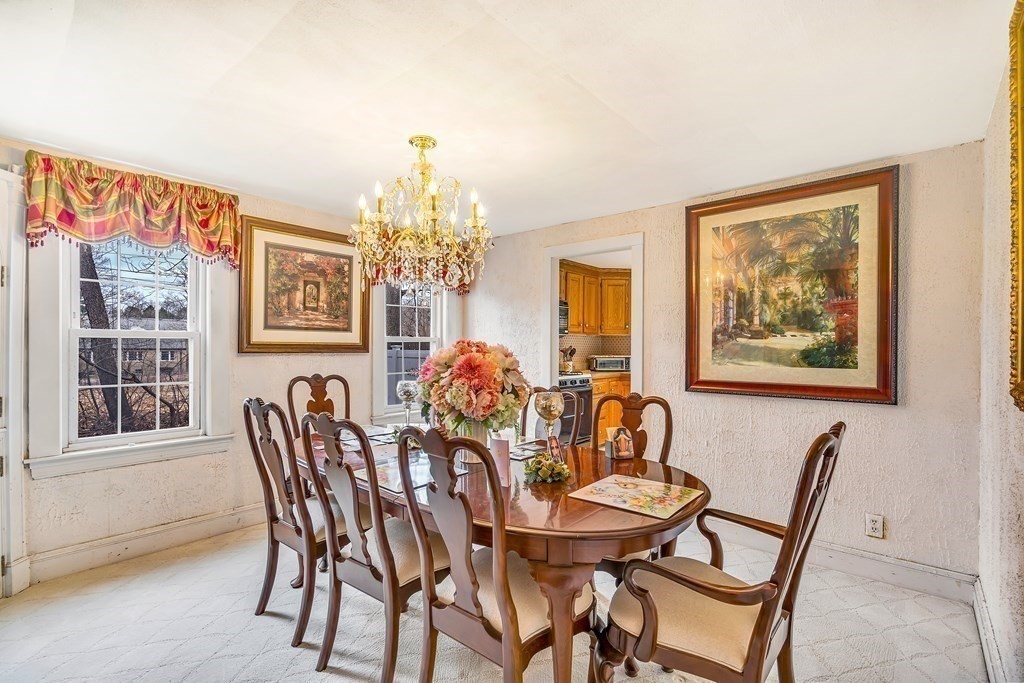105 Hartford Street Natick, MA 01760 - Photo 19 of 41 a view of a dining room with furniture and chandelier