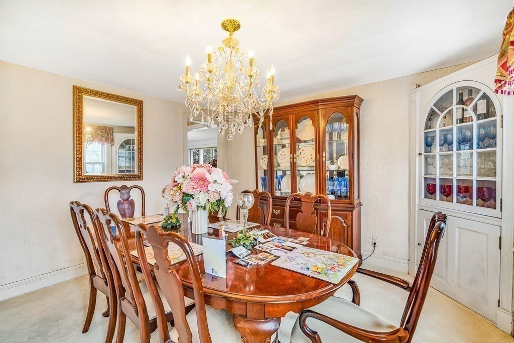 105 Hartford Street Natick, MA 01760 - Photo 20 of 41 a view of a dining room with furniture and chandelier