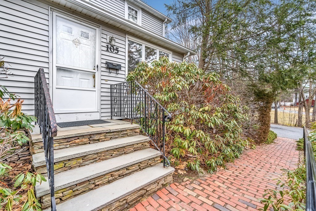 105 Hartford Street Natick, MA 01760 - Photo 2 of 41 a view of a pathway of a house with a window and wooden fence
