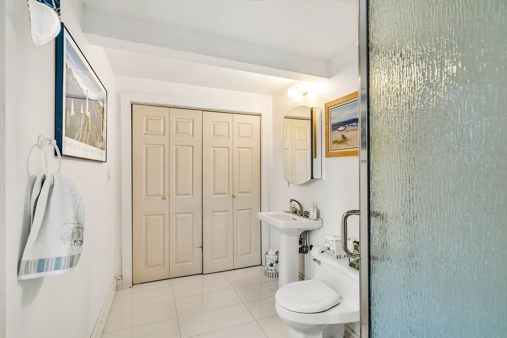 105 Hartford Street Natick, MA 01760 - Photo 21 of 41 a bathroom with a toilet a sink and shower