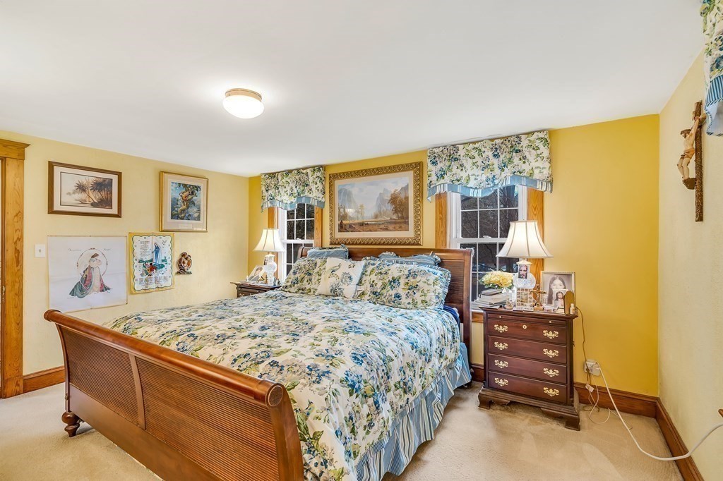 105 Hartford Street Natick, MA 01760 - Photo 26 of 41 a bedroom with a bed and wooden floor