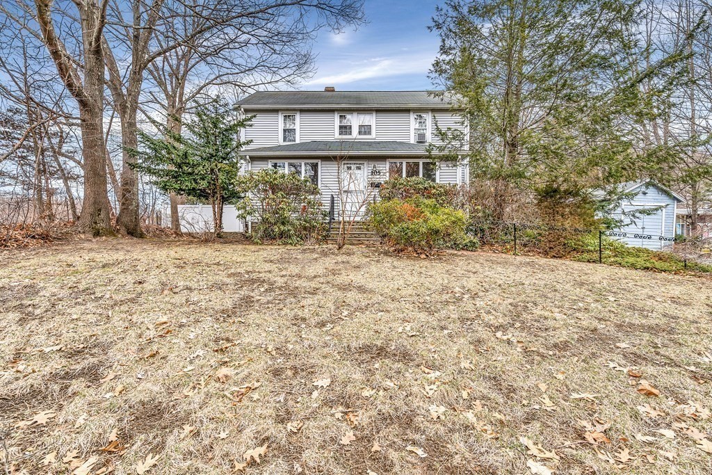 105 Hartford Street Natick, MA 01760 - Photo 6 of 41 a front view of a house with a yard