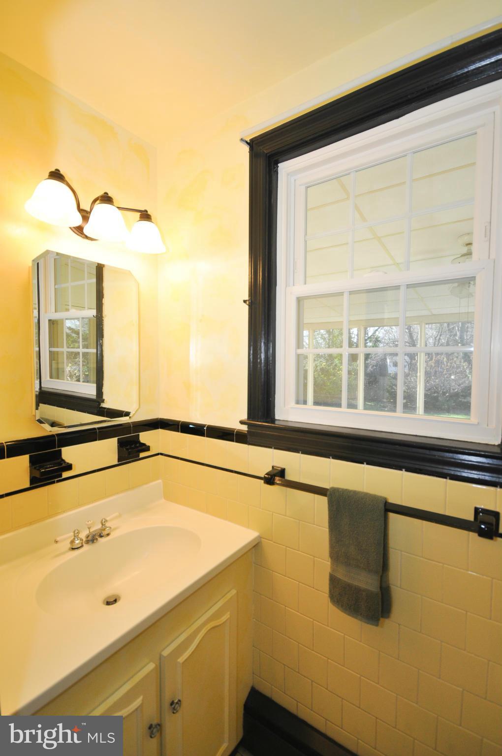 409 Aigburth Road Baltimore, MD 21286 - Photo 14 of 27 a bathroom with a tub sink and mirror