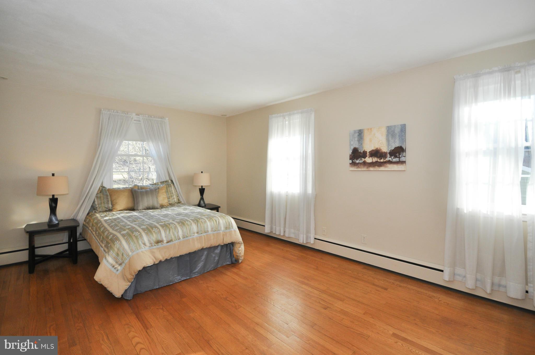 409 Aigburth Road Baltimore, MD 21286 - Photo 16 of 27 a bedroom with a bed and wooden floor