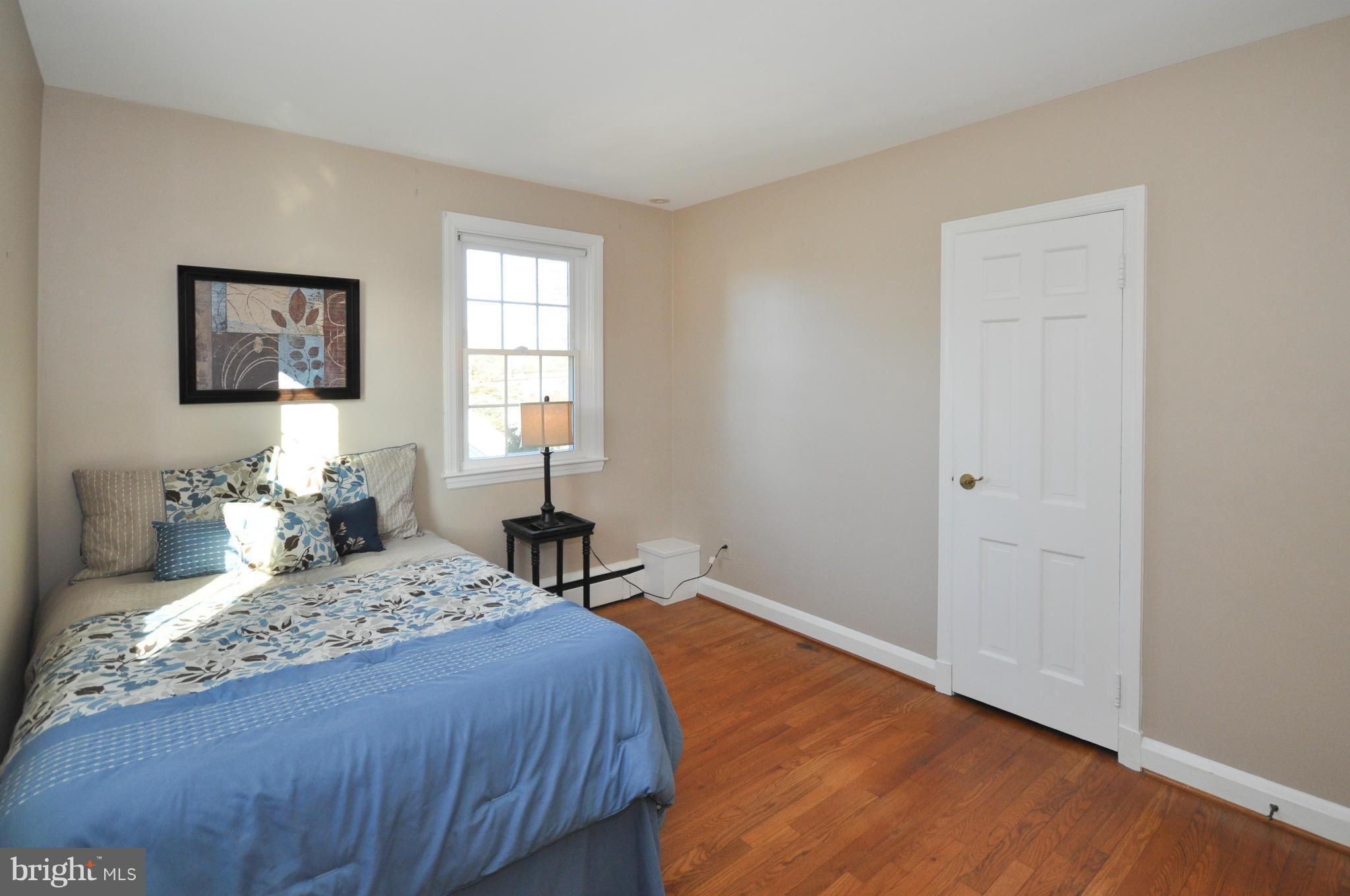 409 Aigburth Road Baltimore, MD 21286 - Photo 19 of 27 a bedroom with a bed and wooden floor