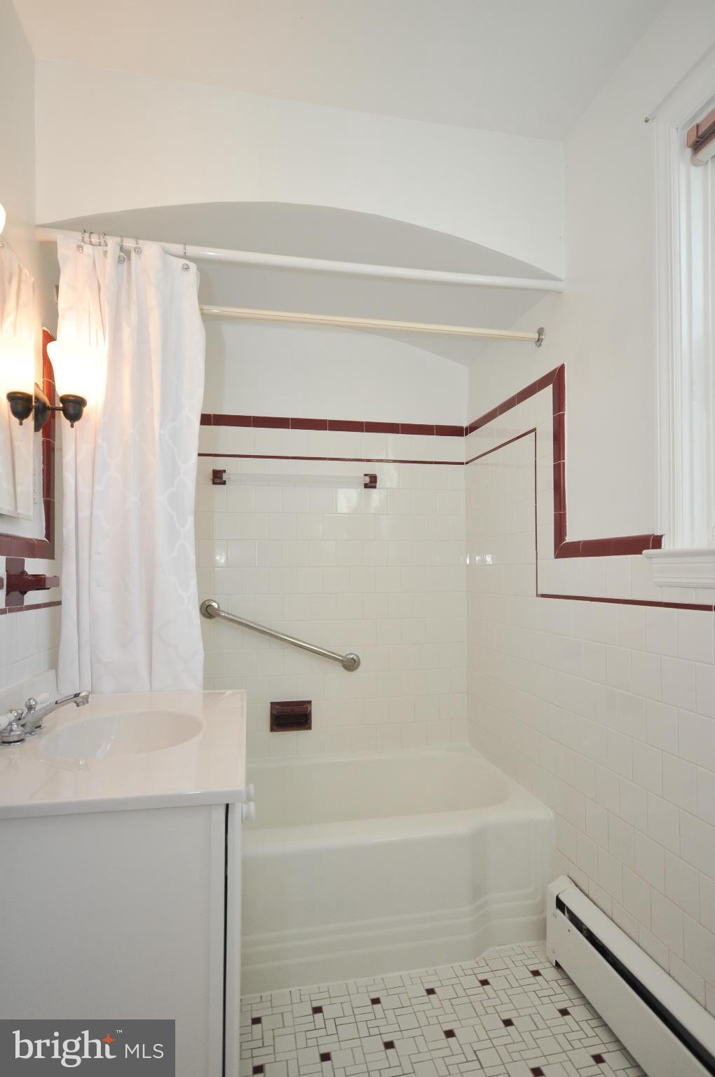 409 Aigburth Road Baltimore, MD 21286 - Photo 22 of 27 a bathroom with a bathtub a sink and a shower