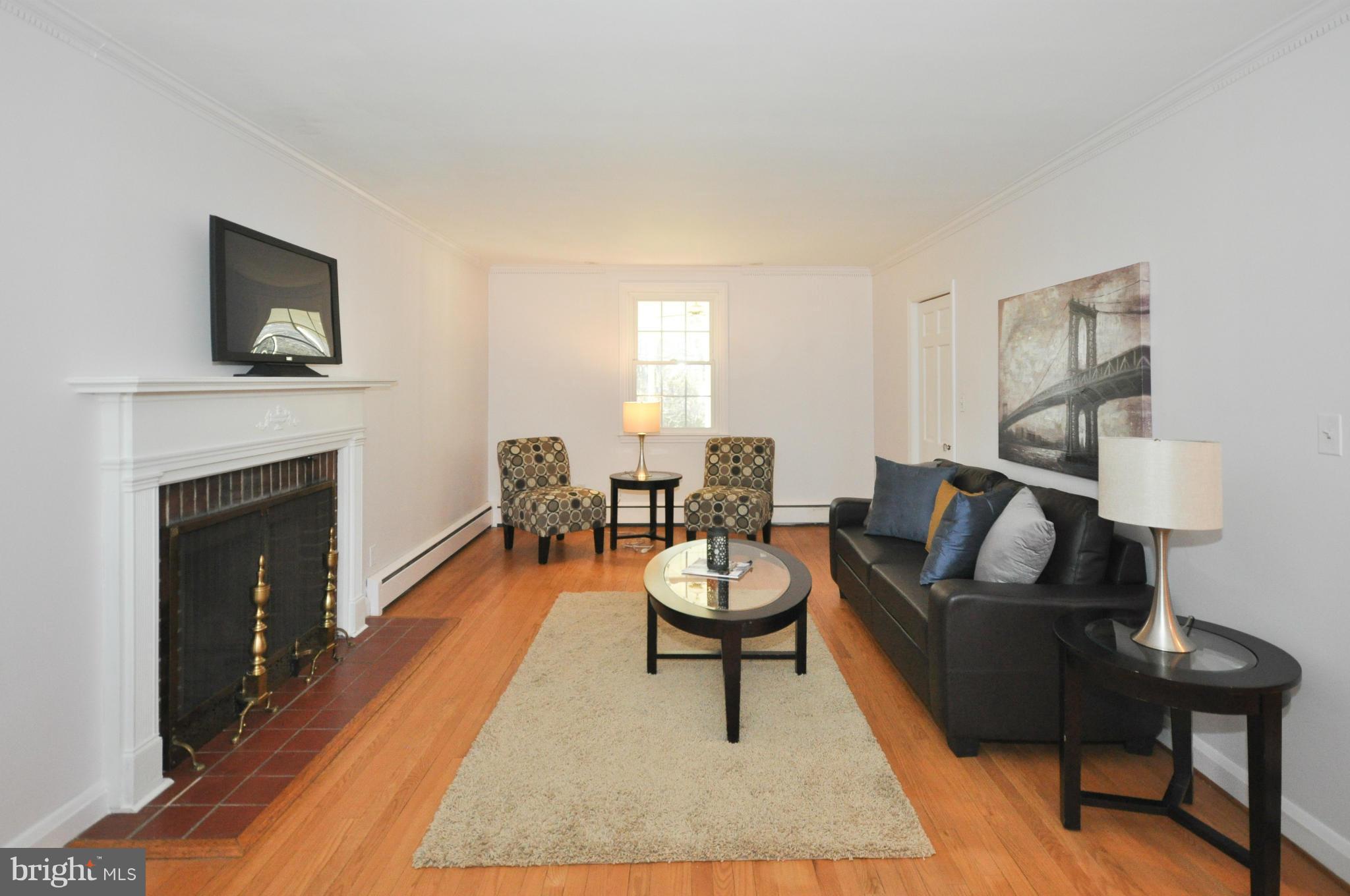 409 Aigburth Road Baltimore, MD 21286 - Photo 4 of 27 a living room with furniture and a fireplace