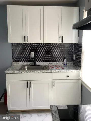 a kitchen with a sink and cabinets