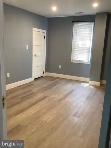 an empty room with closet and window