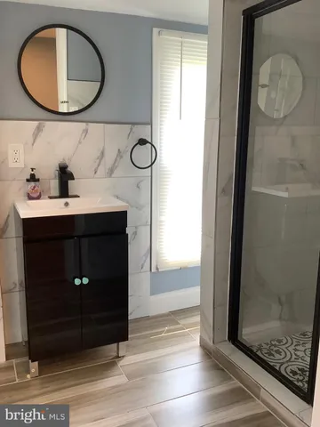a bathroom with a sink a mirror and a shower