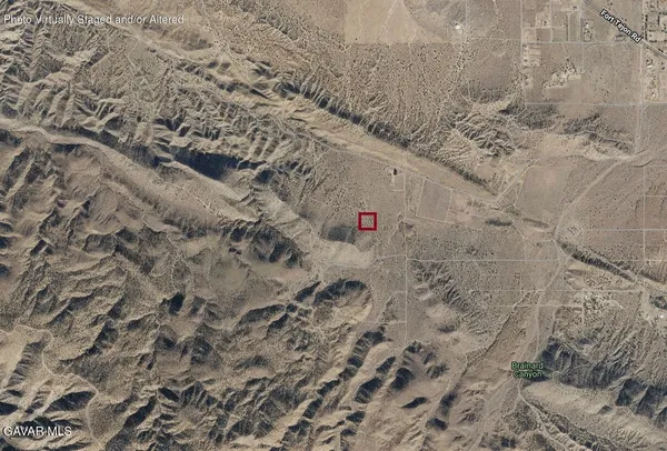 a close up of a dry ground with white house
