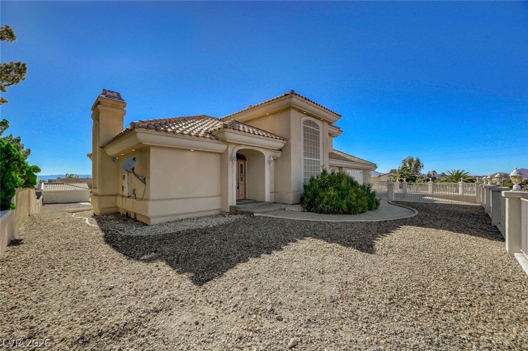 640 North Racetrack Road Henderson, NV 89015 - Photo 3 of 65 A well-maintained facade with Mediterranean-inspired architecture and a welcoming arched entryway.