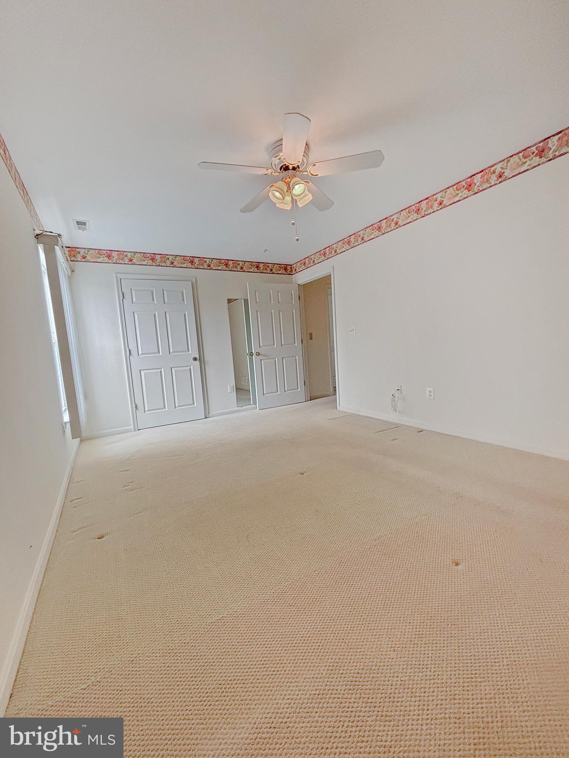 2023 Rudy Serra Drive, Unit 2D Eldersburg, MD 21784 - Photo 7 of 25 a view of a livingroom with a ceiling fan and window