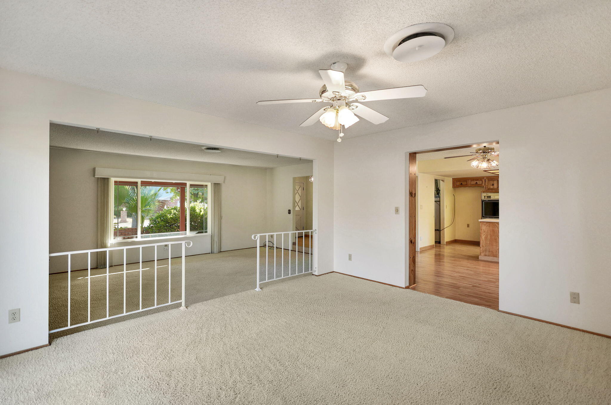 3420 Riverview Drive Redding, CA 96001 - Photo 12 of 40 a view of a livingroom with wooden floor and a ceiling fan