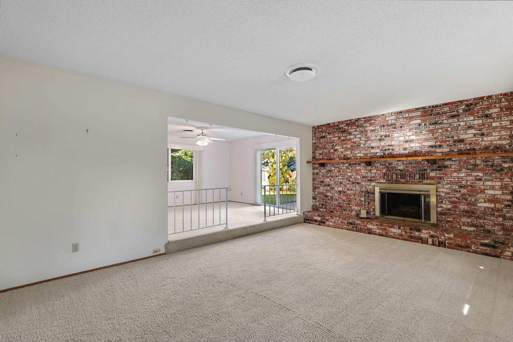 3420 Riverview Drive Redding, CA 96001 - Photo 15 of 40 a view of an empty room with a fireplace and a window