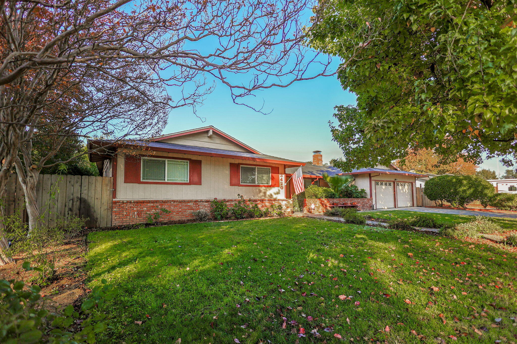 3420 Riverview Drive Redding, CA 96001 - Photo 2 of 40 a front view of a house with a garden and yard