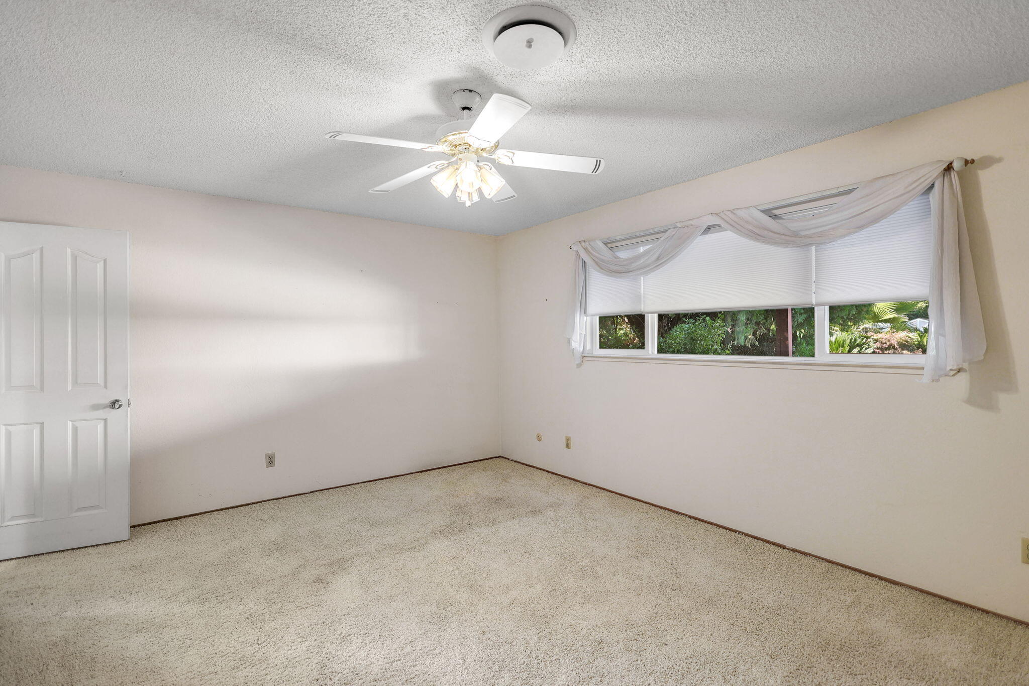 3420 Riverview Drive Redding, CA 96001 - Photo 21 of 40 an empty room with windows and fan