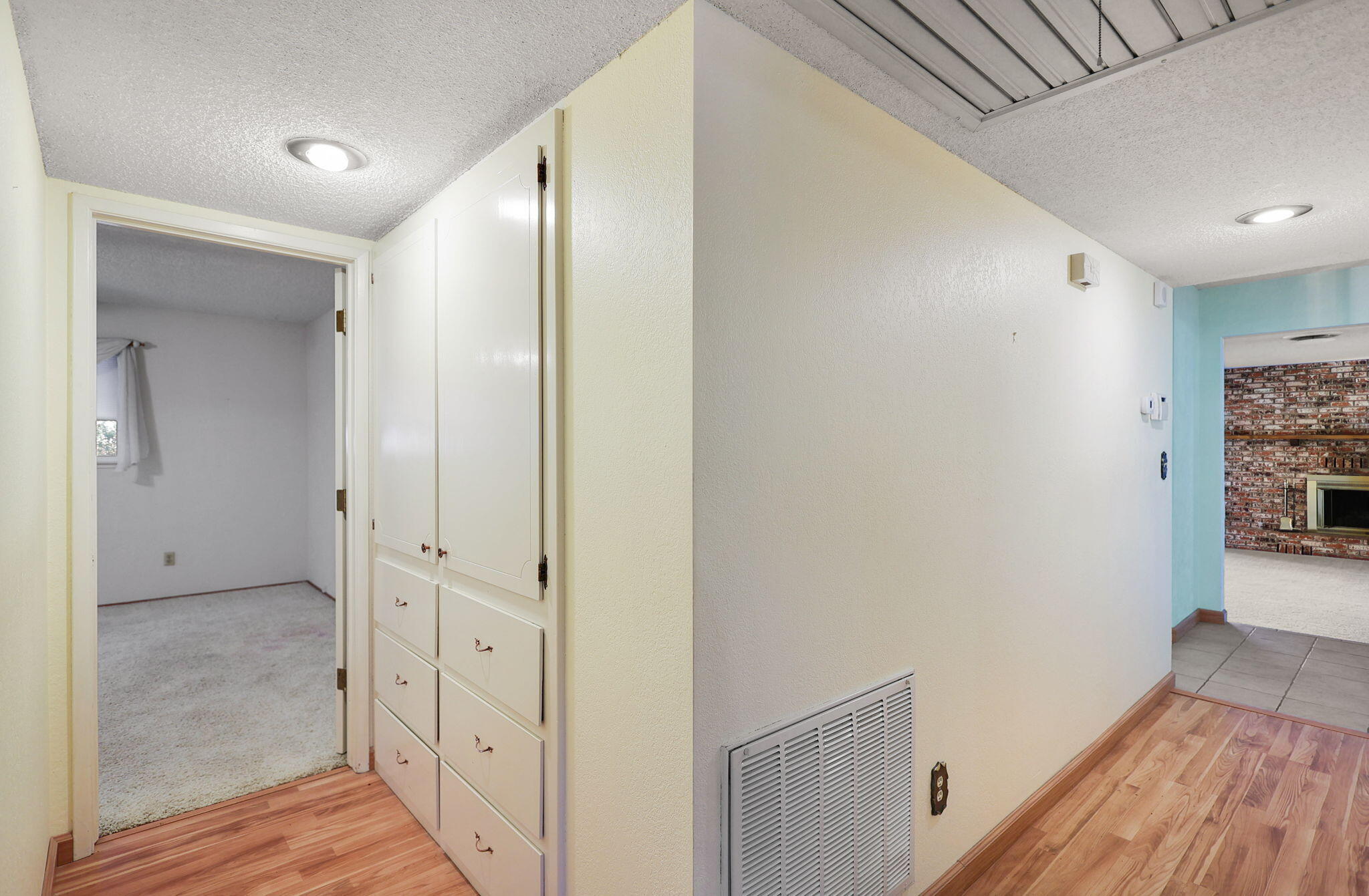 3420 Riverview Drive Redding, CA 96001 - Photo 25 of 40 a view of a hallway with wooden floor and a bathroom