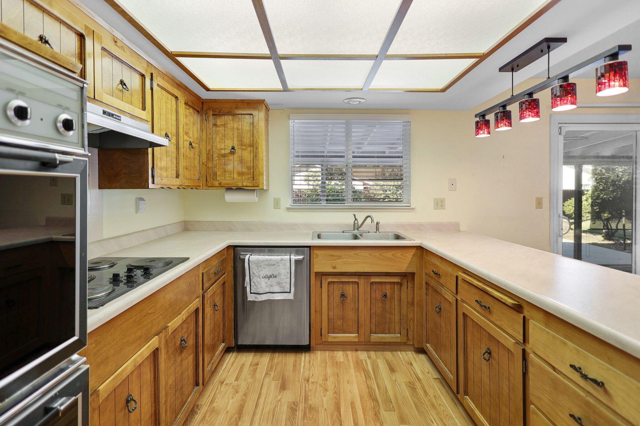 3420 Riverview Drive Redding, CA 96001 - Photo 7 of 40 a kitchen with stainless steel appliances granite countertop a sink and wooden cabinets