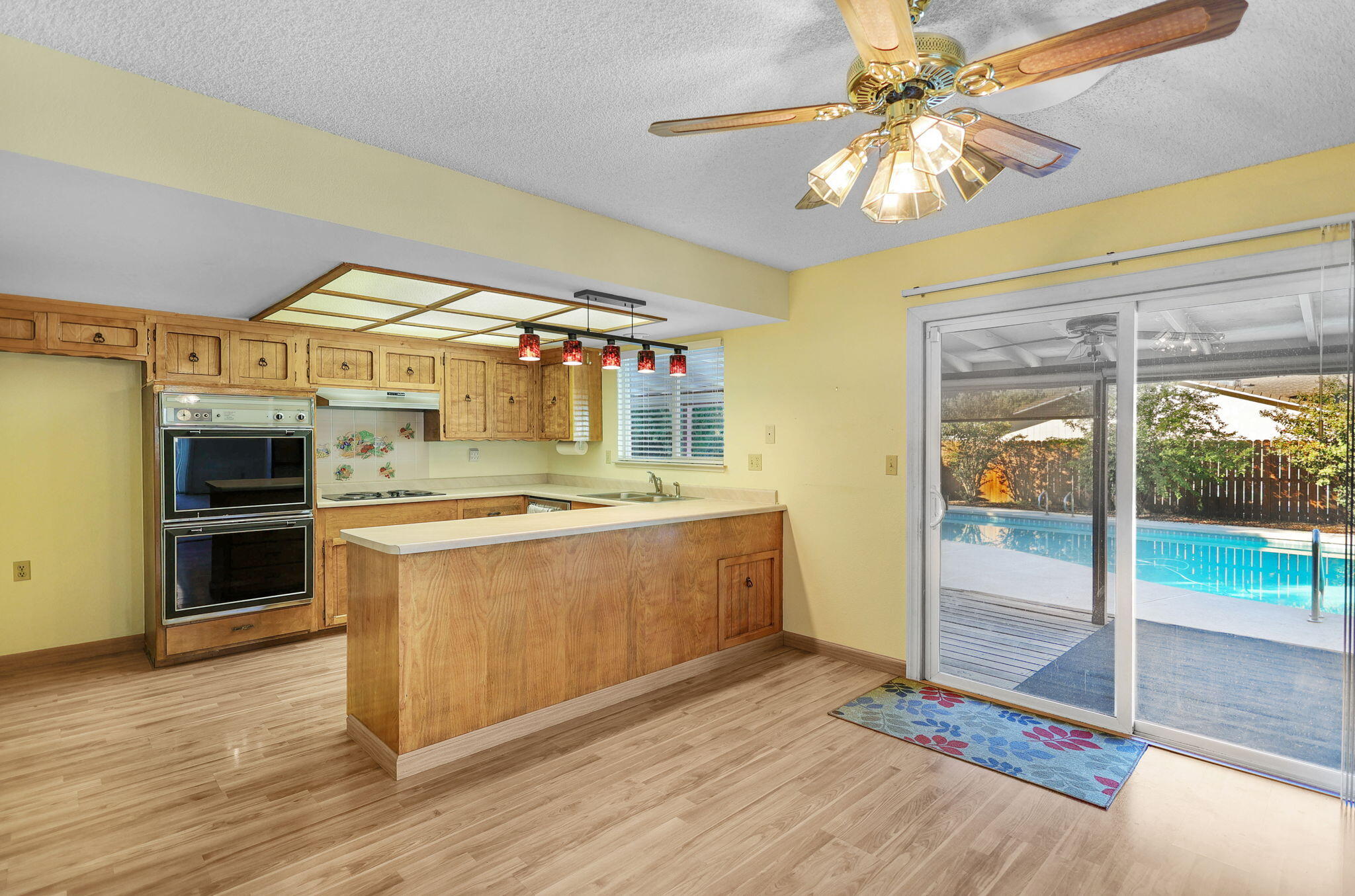 3420 Riverview Drive Redding, CA 96001 - Photo 8 of 40 a large kitchen with stainless steel appliances wooden floor and a counter top space