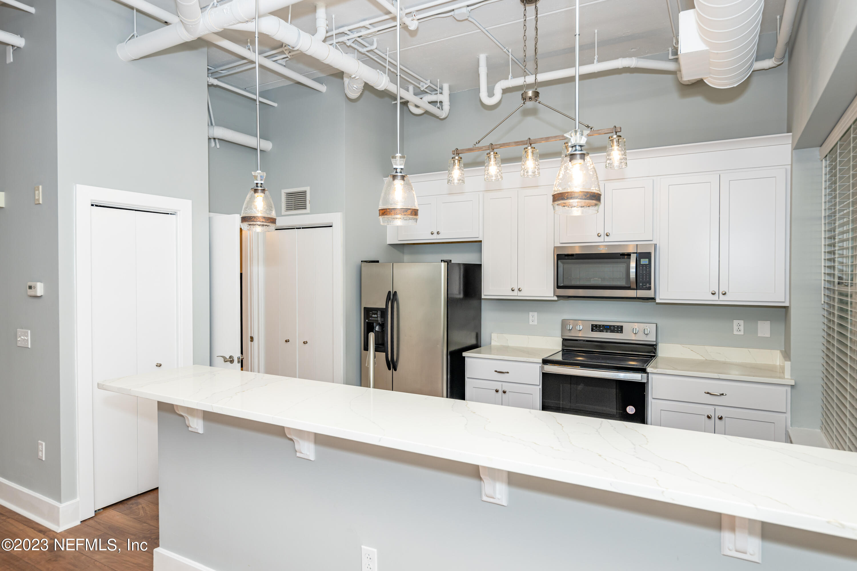 1661 Riverside Avenue, Unit 119 Jacksonville, FL 32204 - Photo 11 of 45 a kitchen with stainless steel appliances a refrigerator and a stove top oven
