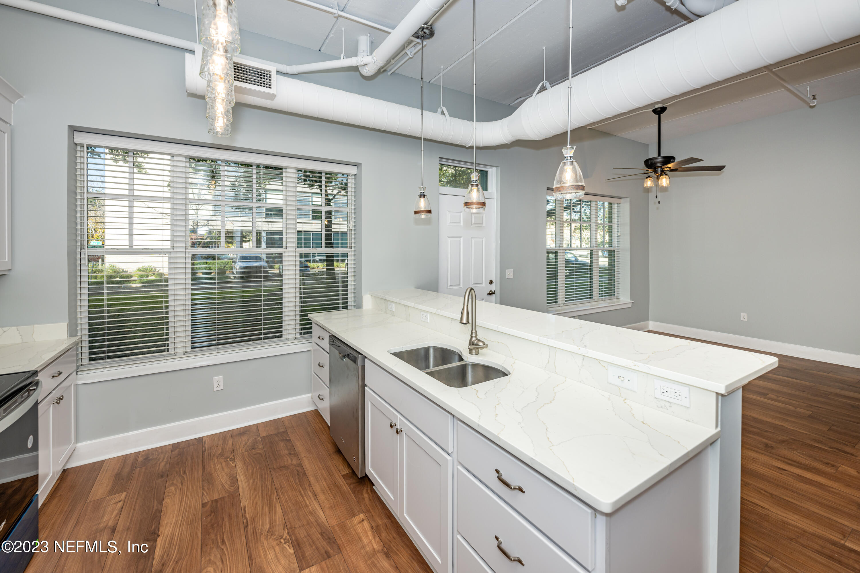 1661 Riverside Avenue, Unit 119 Jacksonville, FL 32204 - Photo 13 of 45 a kitchen with sink cabinets and wooden floor